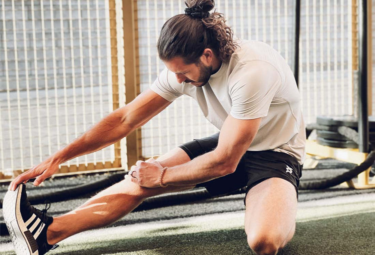 athlete stretching using activebred active short and endurance shirt